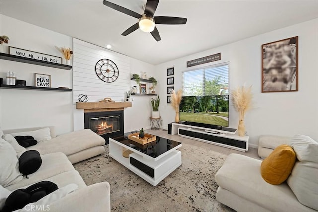 2641 Senna Ln, Palmdale, CA 93551 - living room featuring a glass covered fireplace, a ceiling fan, and wood finished floors