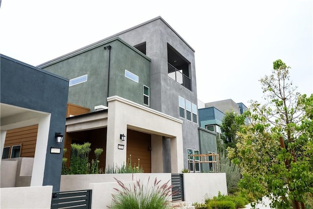 173 Biome, Irvine, CA 92618 - view of front of home with stucco siding and a balcony