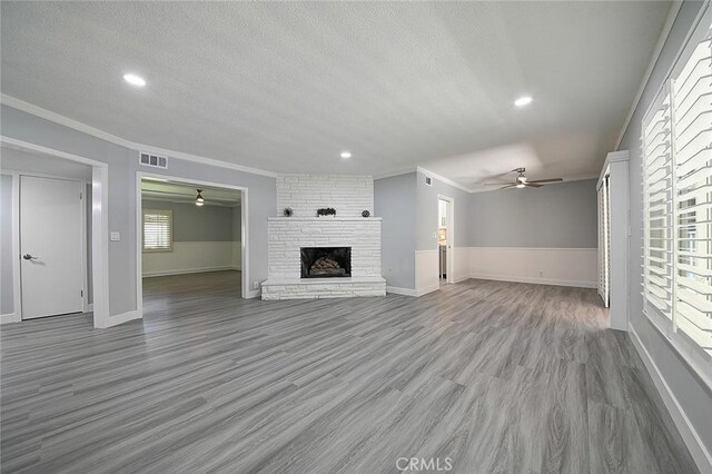 11471 Gill Dr, Garden Grove, CA 92841 - unfurnished living room featuring a ceiling fan, crown molding, a textured ceiling, a fireplace, and recessed lighting