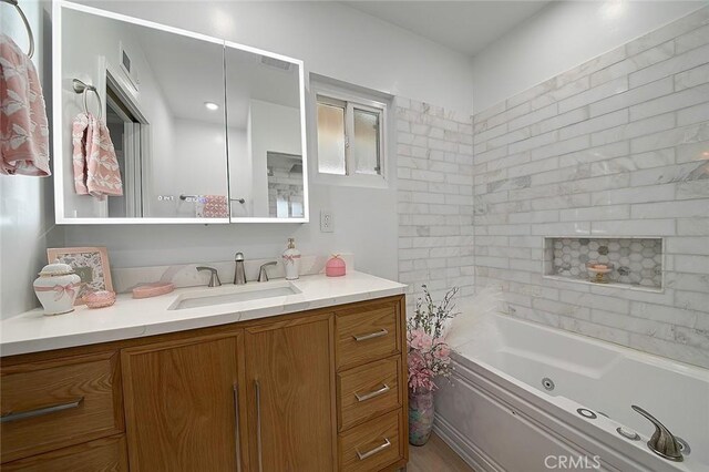 11471 Gill Dr, Garden Grove, CA 92841 - bathroom with vanity, a combined bath / shower with jetted tub, and wood finished floors
