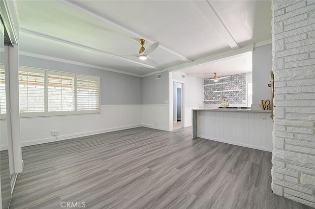 11471 Gill Dr, Garden Grove, CA 92841 - unfurnished living room featuring wood finished floors, a ceiling fan, ornamental molding, and a wainscoted wall
