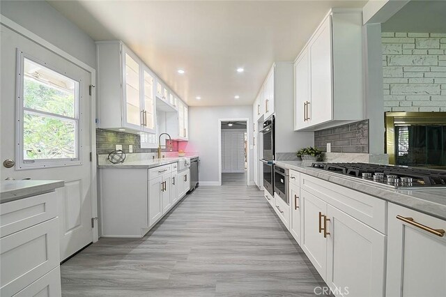 11471 Gill Dr, Garden Grove, CA 92841 - kitchen featuring stainless steel appliances, white cabinetry, backsplash, glass insert cabinets, and recessed lighting