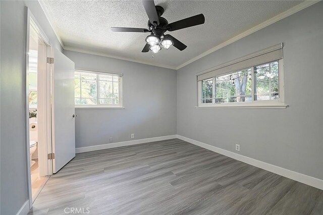 11471 Gill Dr, Garden Grove, CA 92841 - unfurnished room with plenty of natural light, a textured ceiling, wood finished floors, ornamental molding, and a ceiling fan