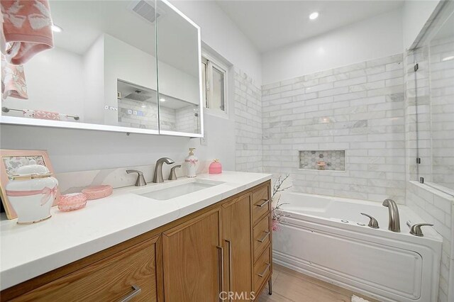 11471 Gill Dr, Garden Grove, CA 92841 - full bath with a garden tub, vanity, a shower, and wood finished floors