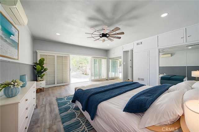11471 Gill Dr, Garden Grove, CA 92841 - bedroom featuring an AC wall unit, light wood-style flooring, a wainscoted wall, recessed lighting, and a ceiling fan