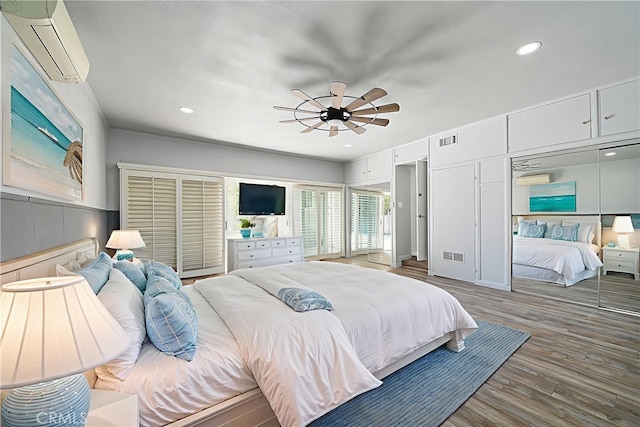 11471 Gill Dr, Garden Grove, CA 92841 - bedroom with a wall mounted AC, wood finished floors, recessed lighting, and a ceiling fan