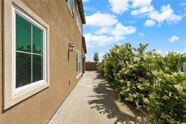 20748 Beech Cir, Porter Ranch, CA 91311 - view of side of home featuring stucco siding and a patio area