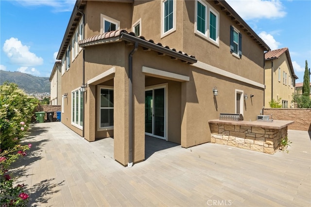20748 Beech Cir, Porter Ranch, CA 91311 - back of house featuring a patio, stucco siding, and a mountain view