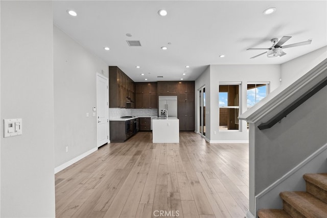 20748 Beech Cir, Porter Ranch, CA 91311 - kitchen featuring open floor plan, stainless steel built in fridge, dark brown cabinetry, a center island with sink, and recessed lighting