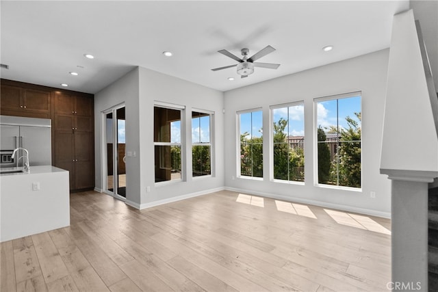 20748 Beech Cir, Porter Ranch, CA 91311 - unfurnished living room featuring recessed lighting, ceiling fan, baseboards, light wood-style floors, and a sink