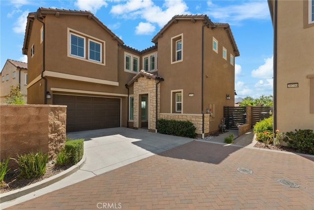 20748 Beech Cir, Porter Ranch, CA 91311 - view of front of home with decorative driveway, a garage, stone siding, stucco siding, and a tile roof