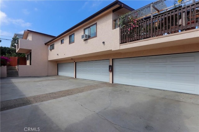2616 Voorhees Ave Unit 2, Redondo Beach, CA 90278 - rear view of property with stucco siding, an attached garage, driveway, and cooling unit