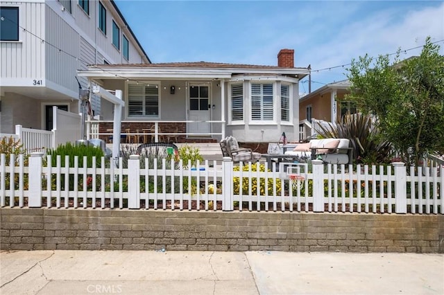 401 6th St, Manhattan Beach, CA 90266 - view of front facade with a chimney, covered porch, and a fenced front yard