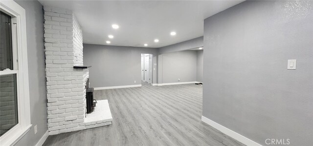 21483 US Highway 18, Apple Valley, CA 92307 - unfurnished living room with baseboards, wood finished floors, recessed lighting, and a brick fireplace