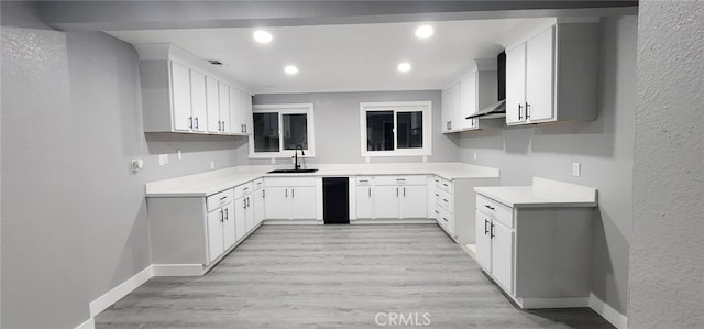 21483 US Highway 18, Apple Valley, CA 92307 - kitchen featuring a sink, baseboards, wall chimney range hood, light wood finished floors, and a textured wall