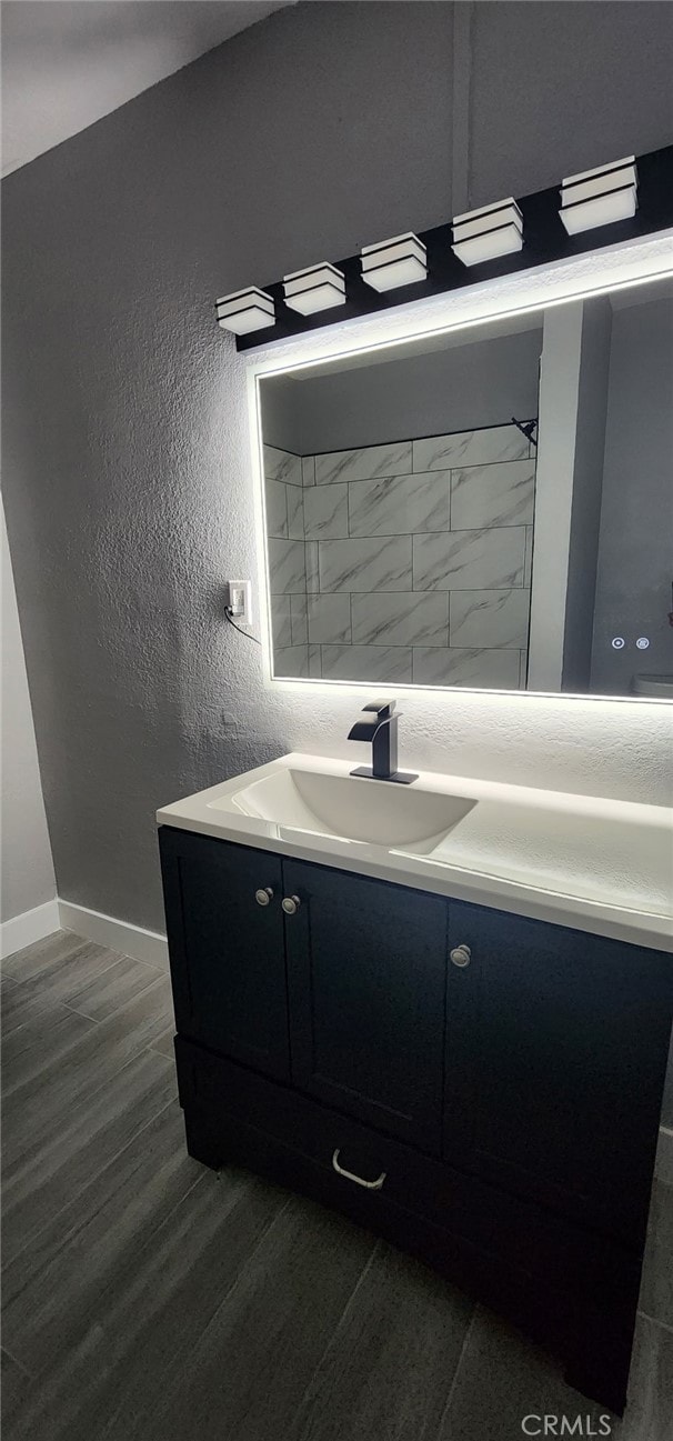 21483 US Highway 18, Apple Valley, CA 92307 - bathroom featuring vanity, wood finished floors, baseboards, and a textured wall