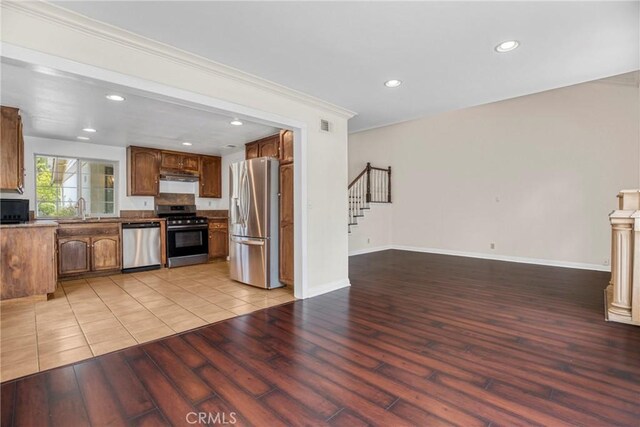 19554 Crystal Ridge Ln, Porter Ranch, CA 91326 - kitchen with appliances with stainless steel finishes, light wood-type flooring, recessed lighting, ornamental molding, and open floor plan