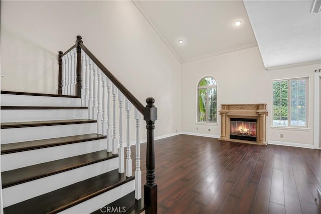 19554 Crystal Ridge Ln, Porter Ranch, CA 91326 - unfurnished living room featuring plenty of natural light, crown molding, wood finished floors, a glass covered fireplace, and baseboards