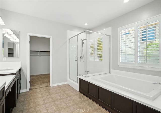 35414 Laurel Tree Ct, Winchester, CA 92596 - bathroom featuring a shower stall, vanity, a garden tub, a spacious closet, and recessed lighting