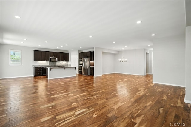 35414 Laurel Tree Ct, Winchester, CA 92596 - unfurnished living room with a chandelier, dark wood-style floors, and recessed lighting