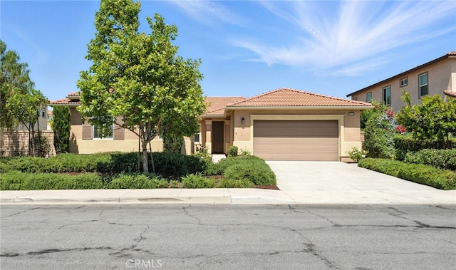 35414 Laurel Tree Ct, Winchester, CA 92596 - view of front of property featuring an attached garage, stucco siding, concrete driveway, and a tiled roof