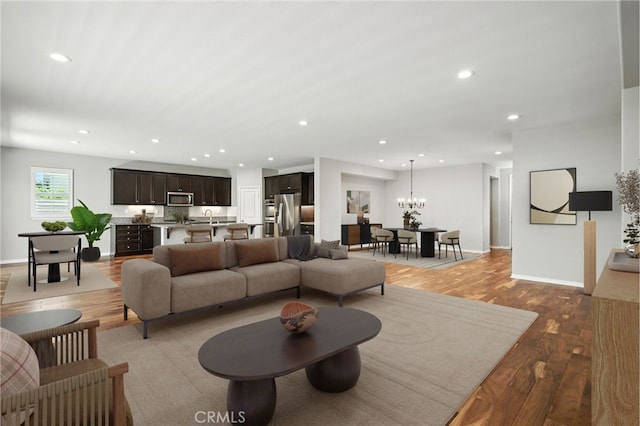 35414 Laurel Tree Ct, Winchester, CA 92596 - living room featuring wood finished floors, recessed lighting, and a chandelier
