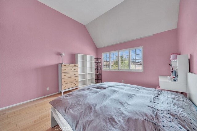 230 Bethany Rd Unit 127, Burbank, CA 91504 - bedroom featuring wood finished floors, vaulted ceiling, and baseboards
