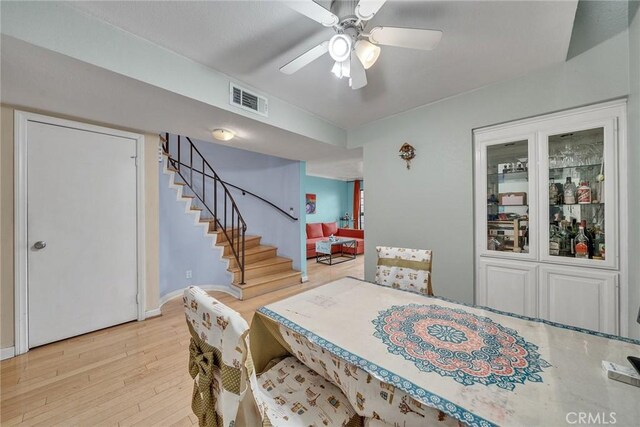 230 Bethany Rd Unit 127, Burbank, CA 91504 - dining room with stairs, ceiling fan, wood finished floors, and baseboards