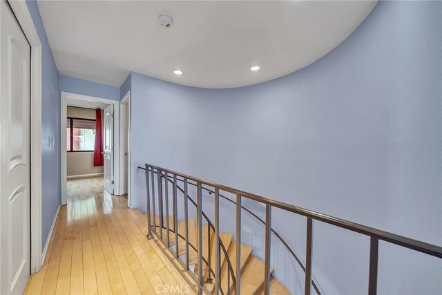 230 Bethany Rd Unit 127, Burbank, CA 91504 - corridor featuring light wood-style flooring, baseboards, recessed lighting, and an upstairs landing