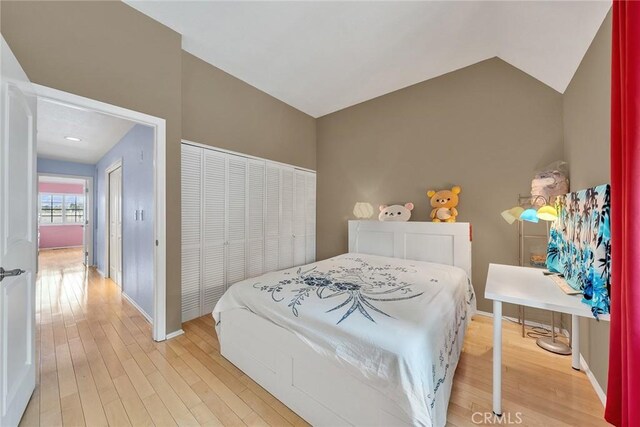 230 Bethany Rd Unit 127, Burbank, CA 91504 - bedroom with light wood finished floors, vaulted ceiling, baseboards, and a closet