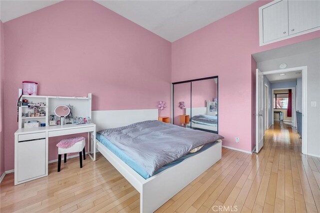 230 Bethany Rd Unit 127, Burbank, CA 91504 - bedroom featuring light wood-style flooring, vaulted ceiling, and baseboards