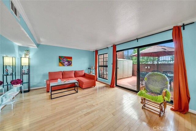 230 Bethany Rd Unit 127, Burbank, CA 91504 - living room featuring wood-type flooring, baseboards, and crown molding