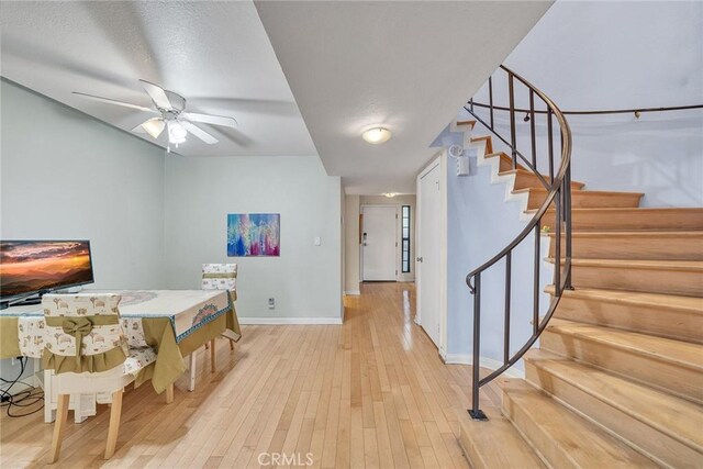 230 Bethany Rd Unit 127, Burbank, CA 91504 - dining room with baseboards, light wood-style floors, stairway, and ceiling fan