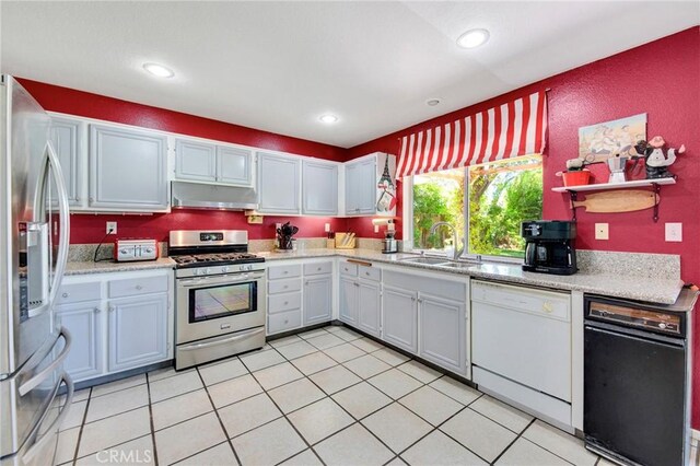 2825 W Newgrove St, Lancaster, CA 93536 - kitchen with appliances with stainless steel finishes, under cabinet range hood, light countertops, a sink, and recessed lighting