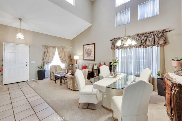 2825 W Newgrove St, Lancaster, CA 93536 - tiled dining area featuring carpet, a high ceiling, and a chandelier