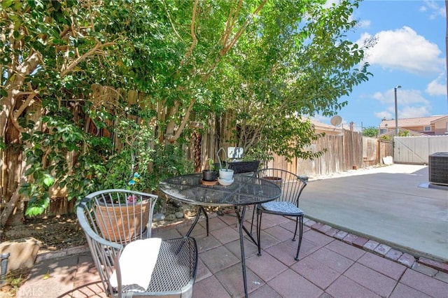 2825 W Newgrove St, Lancaster, CA 93536 - fenced backyard with a patio, outdoor dining area, and cooling unit