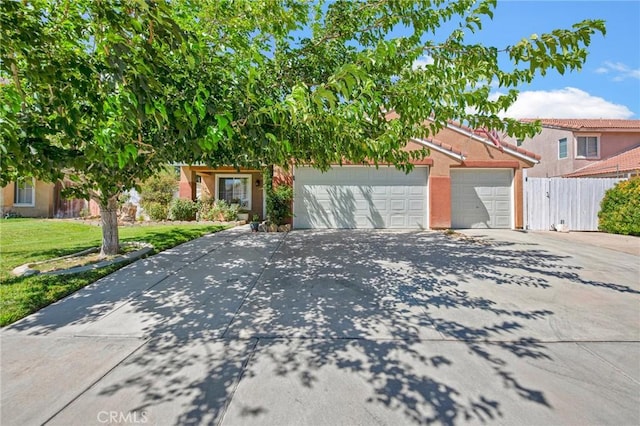 2825 W Newgrove St, Lancaster, CA 93536 - obstructed view of property with concrete driveway, an attached garage, and stucco siding
