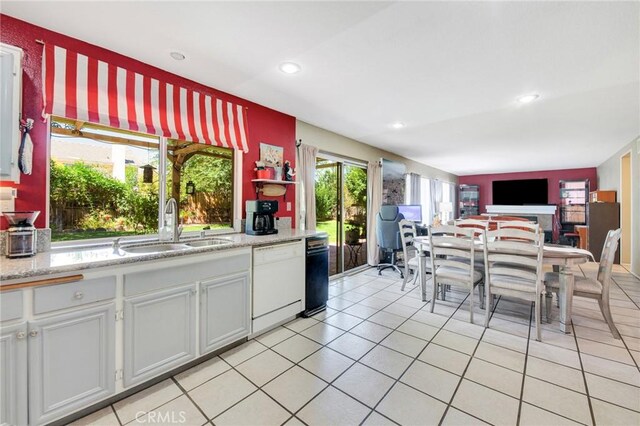 2825 W Newgrove St, Lancaster, CA 93536 - kitchen with white dishwasher, a sink, light tile patterned flooring, recessed lighting, and open shelves