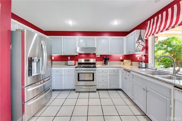 2825 W Newgrove St, Lancaster, CA 93536 - kitchen with stainless steel appliances, a sink, range hood, light countertops, and light tile patterned floors