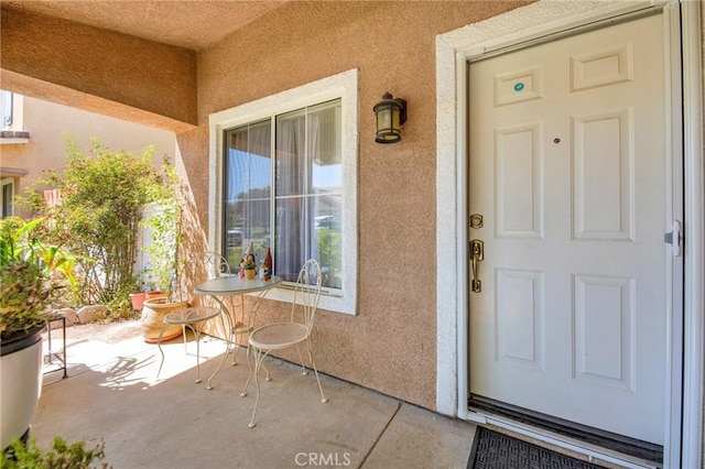 2825 W Newgrove St, Lancaster, CA 93536 - doorway to property with stucco siding and a porch