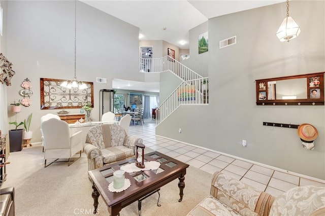 2825 W Newgrove St, Lancaster, CA 93536 - tiled living room with stairway, a towering ceiling, baseboards, and a chandelier