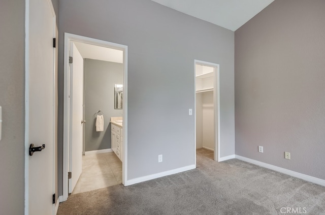 253 Gallery Way, Tustin, CA 92782 - unfurnished bedroom with a walk in closet, light colored carpet, baseboards, a closet, and ensuite bath