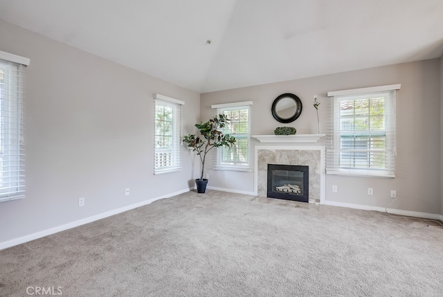 253 Gallery Way, Tustin, CA 92782 - unfurnished living room with plenty of natural light, carpet flooring, lofted ceiling, a fireplace, and baseboards