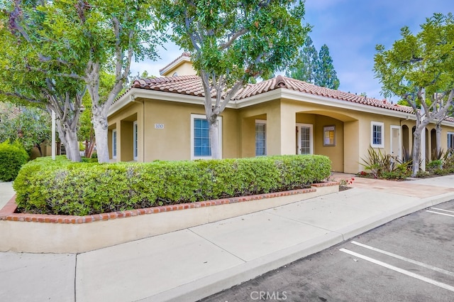 253 Gallery Way, Tustin, CA 92782 - mediterranean / spanish-style home with uncovered parking, stucco siding, and a tile roof