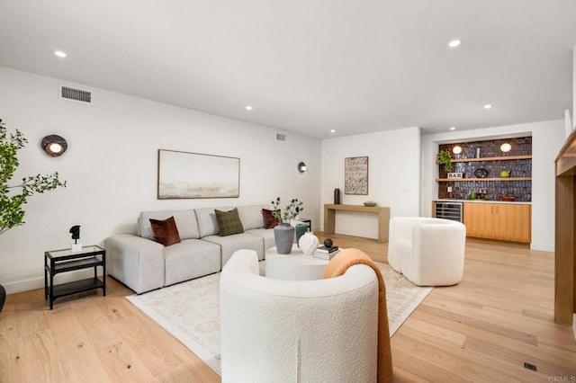 4252 Don Jose Dr, Los Angeles, CA 90008 - living room featuring light wood-style flooring, beverage cooler, recessed lighting, and bar
