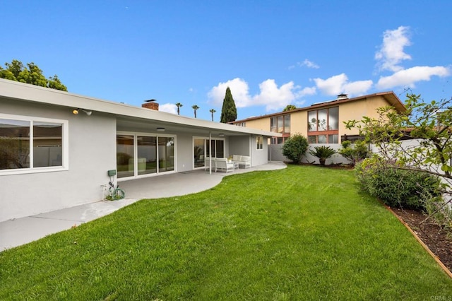 4252 Don Jose Dr, Los Angeles, CA 90008 - rear view of property featuring a patio, a lawn, stucco siding, and a chimney