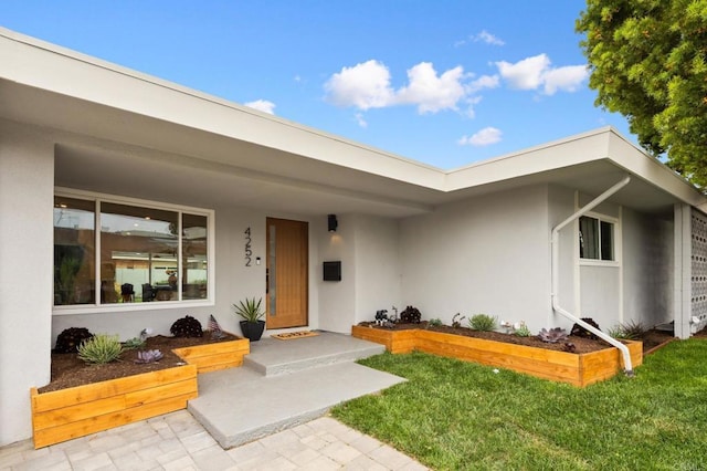 4252 Don Jose Dr, Los Angeles, CA 90008 - property entrance with stucco siding, a yard, and covered porch