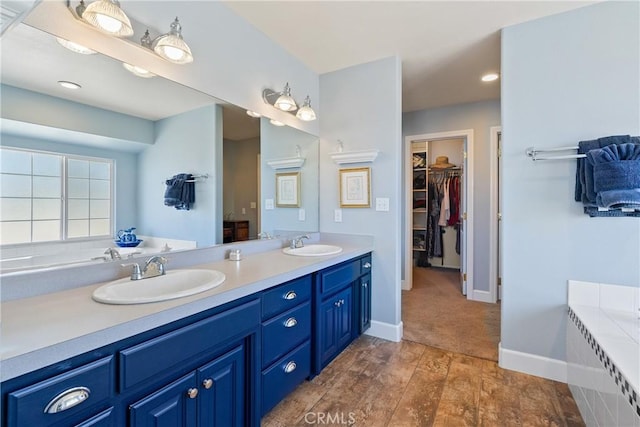 26 Deer View Ln, Templeton, CA 93465 - full bath with double vanity, a bath, a spacious closet, wood finished floors, and baseboards