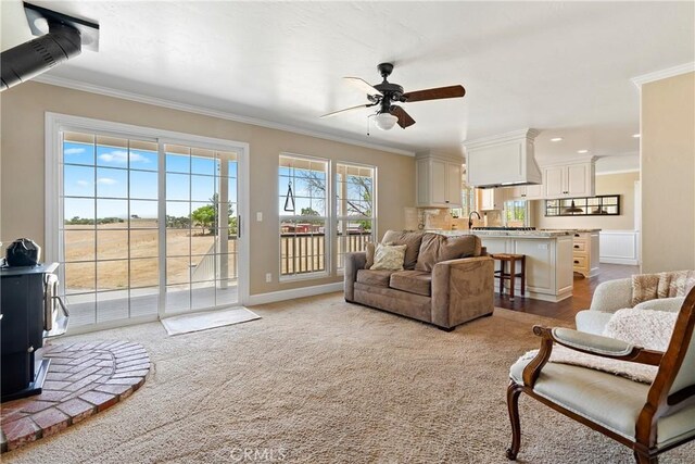 26 Deer View Ln, Templeton, CA 93465 - carpeted living room featuring a wood stove, ceiling fan, ornamental molding, baseboards, and recessed lighting