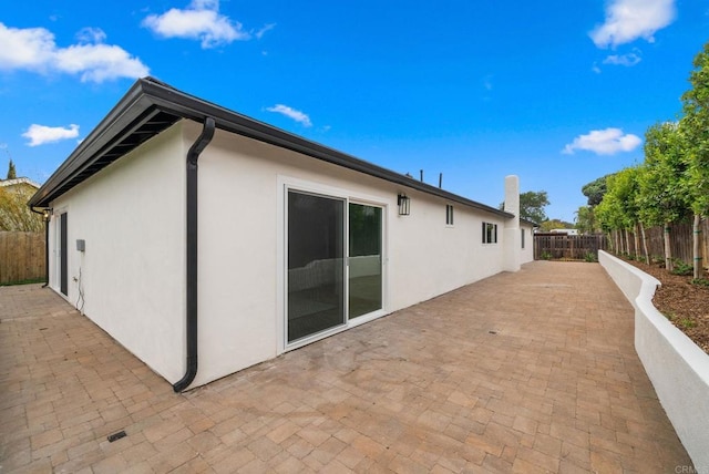 3750 Grecourt Way, Carlsbad, CA 92008 - view of side of home with stucco siding, a patio, and a fenced backyard